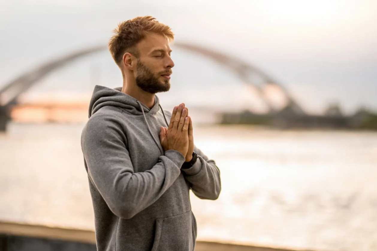 Man practicing gratitude outdoors city background
